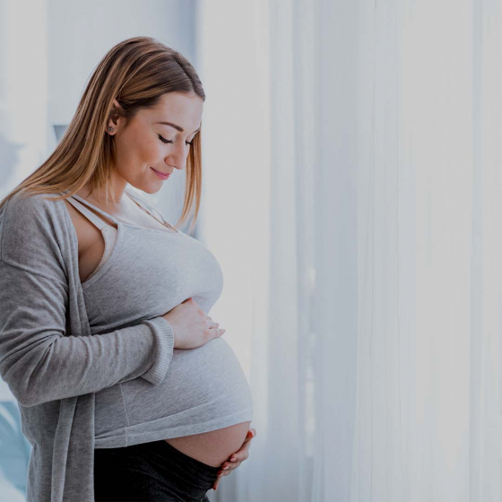 Pregnant woman holding her stomach